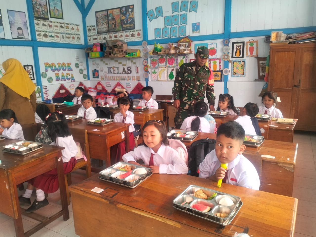 Babinsa Koramil 0819/26 Tosari, Serka Yulianto, turut mendampingi kegiatan pelaksanaan Makan Bergizi Gratis yang digelar di wilayah Kecamatan Tosari,